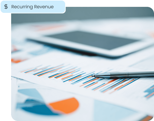 Colorful financial reports and a pen, symbolizing the new recurring revenue stream that associations can generate through a partnership with Aurora Payments.